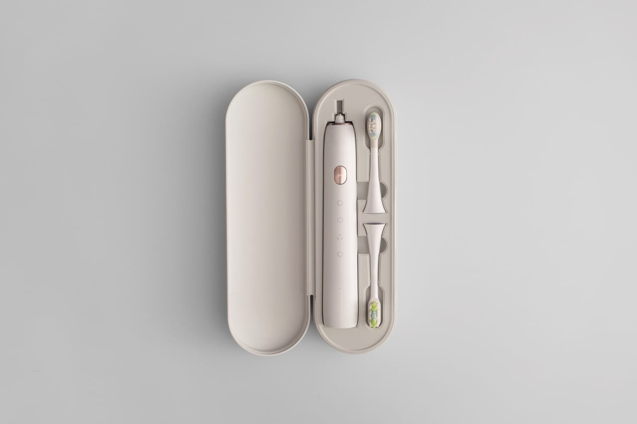 A plastic toothbrush with injection molded elements, serving as an example of injection molding in consumer products