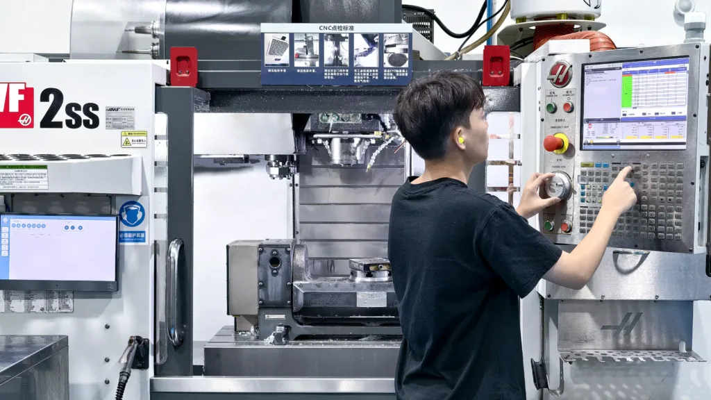 Skilled CNC machinist operating a CNC machining machine for precision metal machining and custom CNC manufacturing.