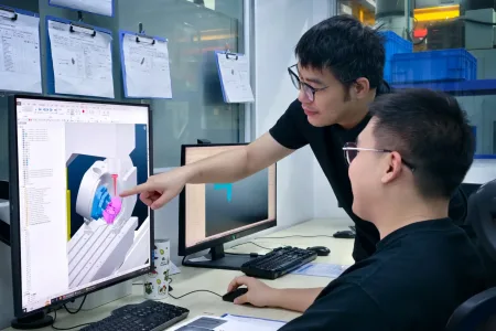 Procision engineers programming a CNC milling operation using 3D CAD software to ensure accurate tool paths and manufacturable design.